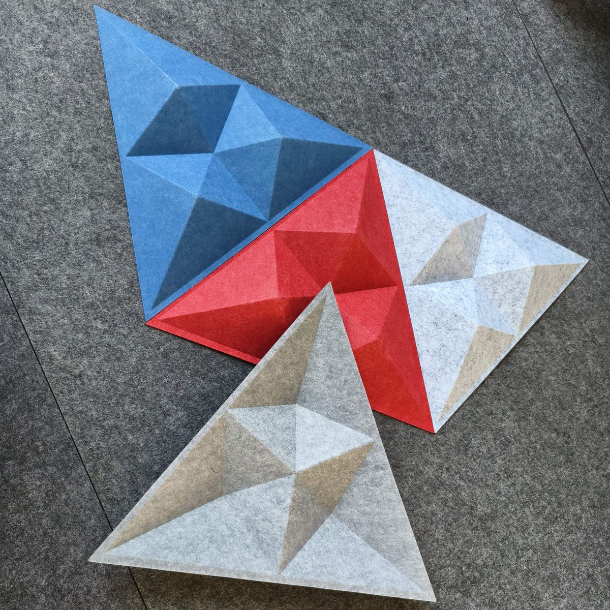 Triángulos facetados de PET en azul, rojo y gris